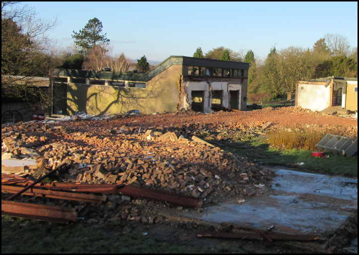Rubble of the Music Block, with the shell of the Music School Salon in the background